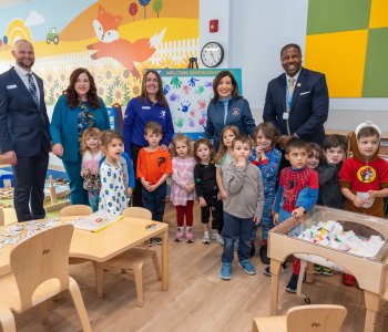 Group posing for photo in Irene Skalny Childcare Center