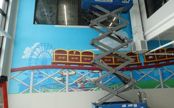 roller coaster artwork on the walls in the sands family ymca adventure center