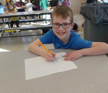 Myles Abernathy drawing at the East Rochester BASP program.