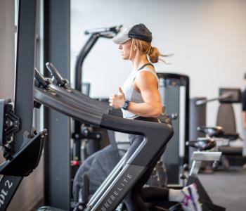 Woman running on a wind runner machine