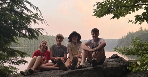 campers sitting by the lake