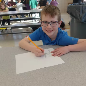Myles Abernathy drawing at the East Rochester BASP program.