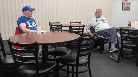 Kevin Hanley and Pastor Anthony Saxton talk during a grieving group session at the Maplewood Family YMCA