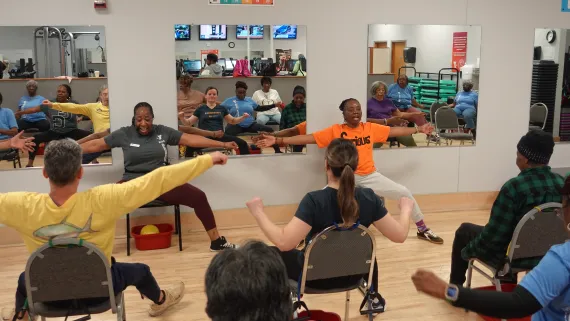 A Rochester Police Department officer joins in Chair Yoga