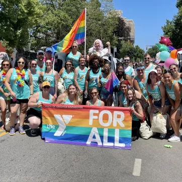 a group photo of ymca of greater rochester staff and volunteers during the 2022 rochester pride parade